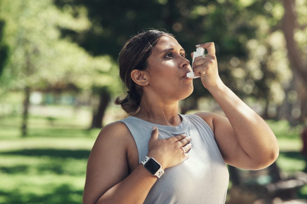 Woman exercising with inhaler